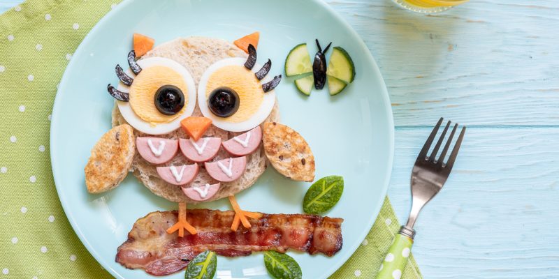 Fun food for kids - cute little owl sandwich toast with sausages and eggs